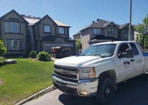 a Vanity Roofing truck on a job site at an Ottawa neighbourhood