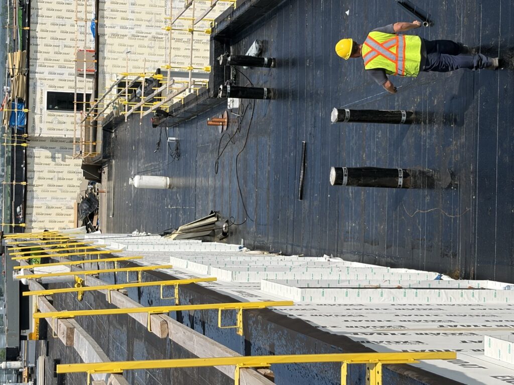 Membrane rolls and torch set up for a torch-on flat roof