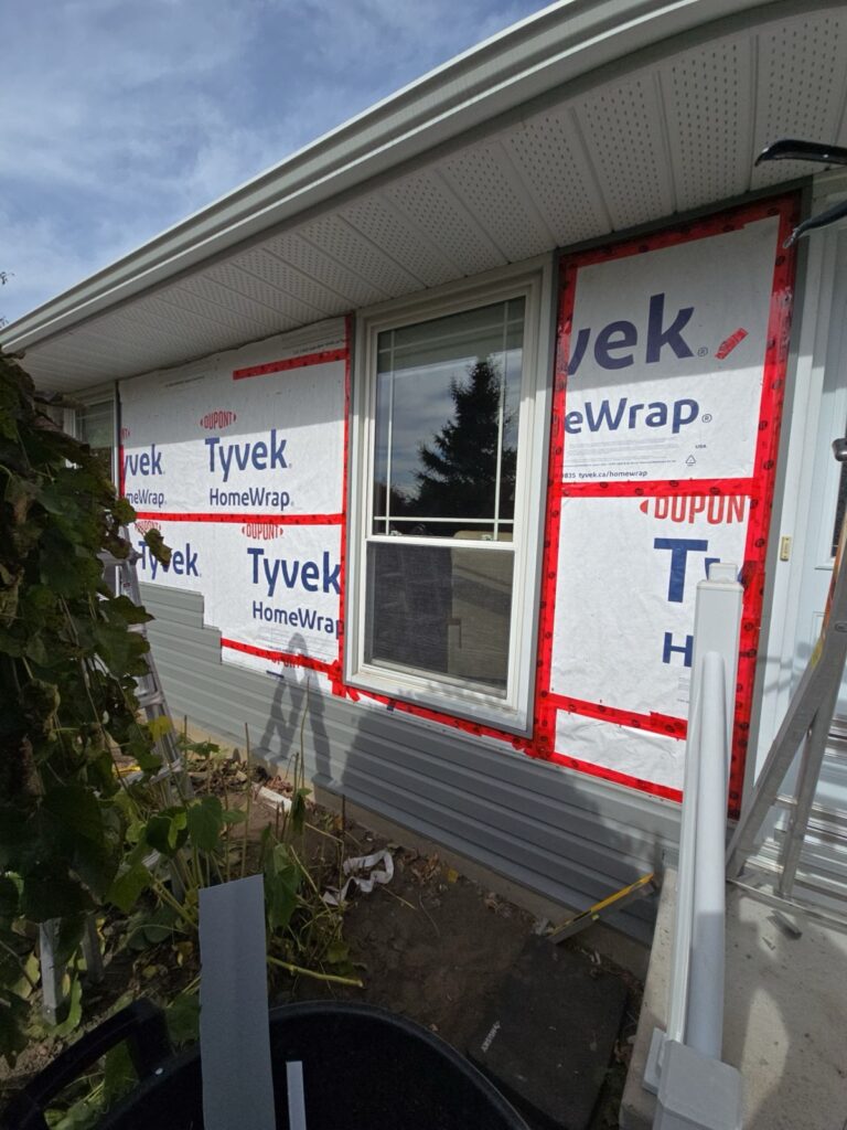 House wrap and new horizontal vinyl siding going up