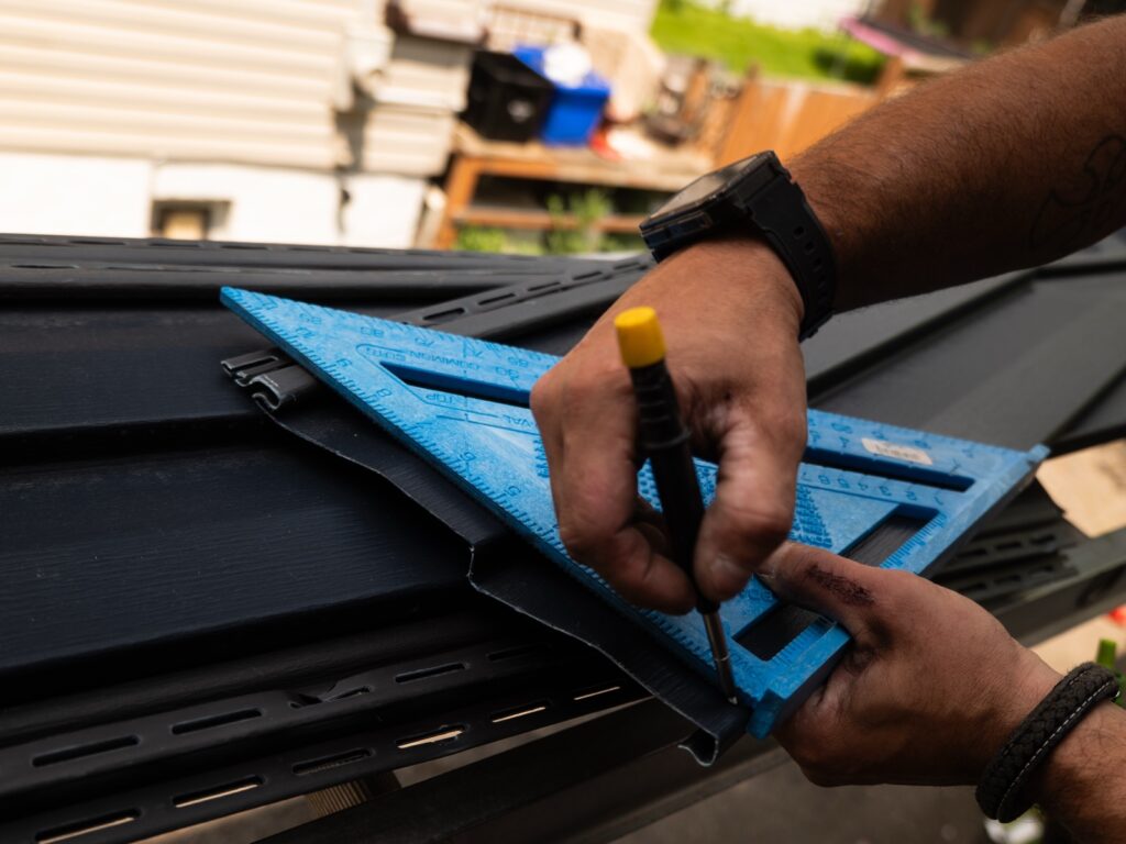 Measuring and marking a siding panel before cutting